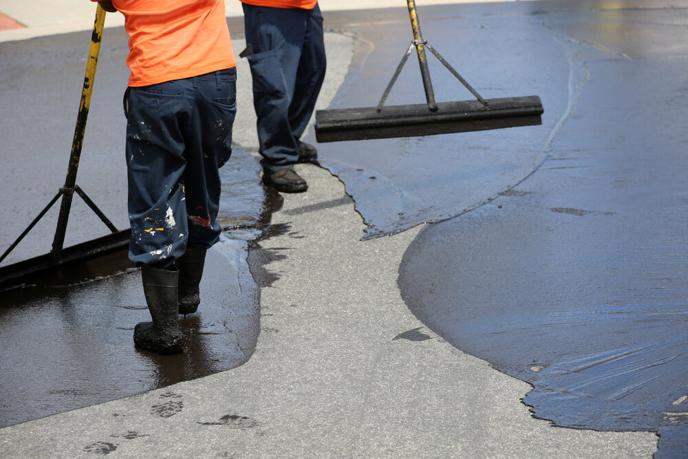Driveway Repair and Maintenance. Seal coating being applied.