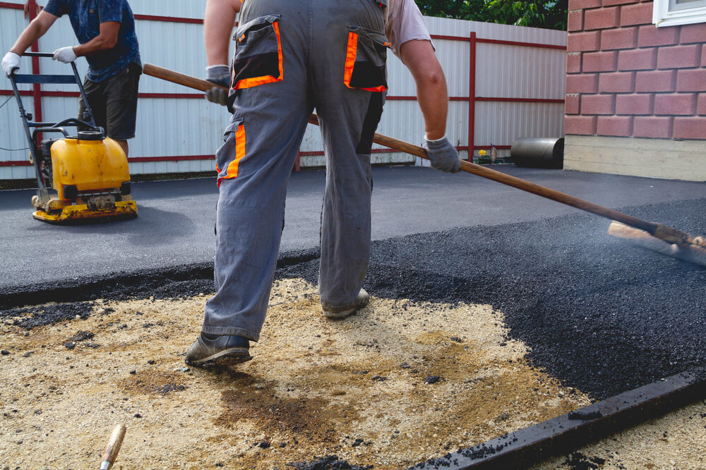 Two Men working on new Asphalt Paving.