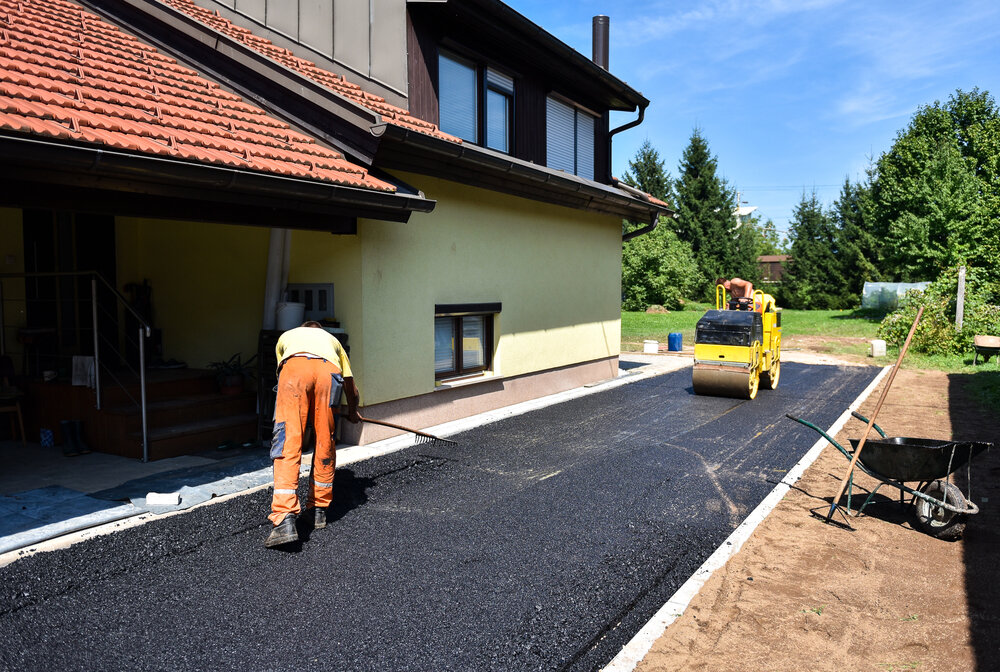 Team of workers preforming Asphalt Paving.