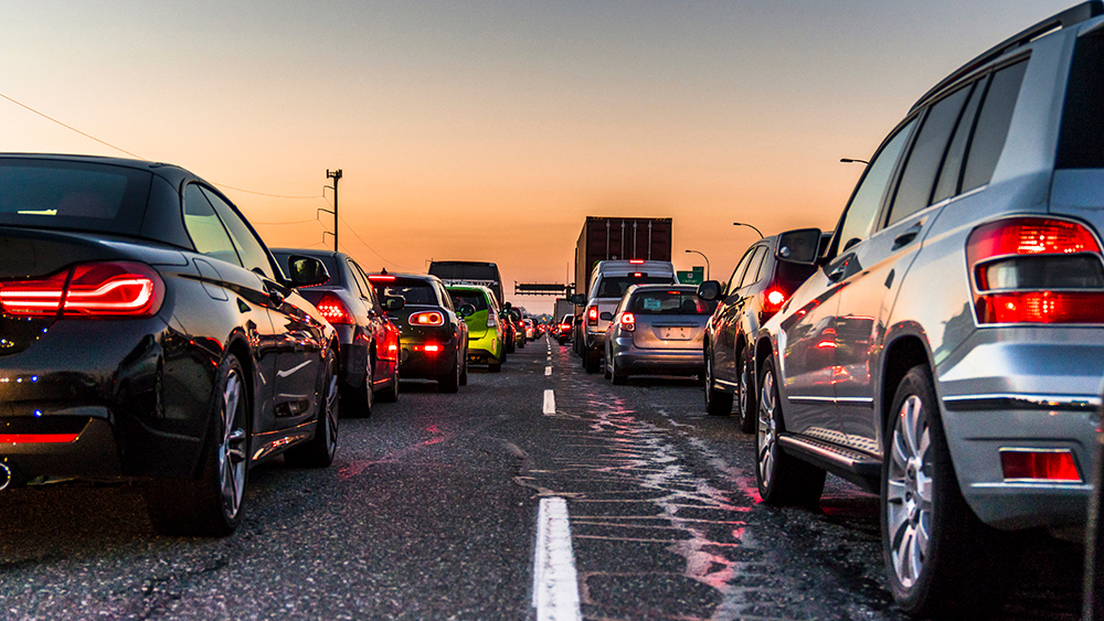 Traffic jam on a busy highway at rush hour with broken asphalt paving