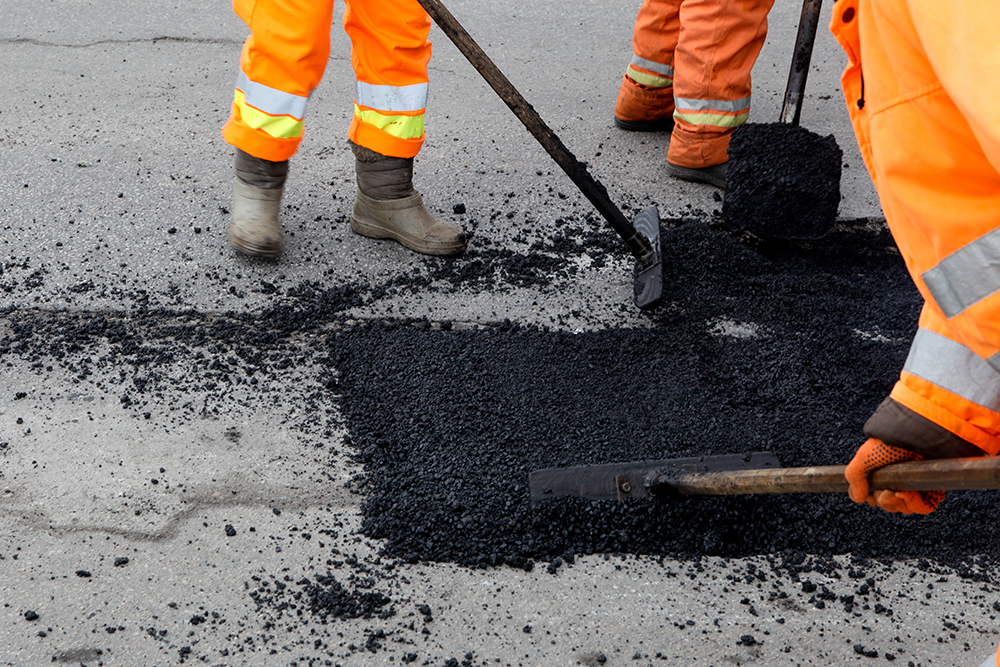 Street resurfacing. Fresh asphalt Maintenance construction