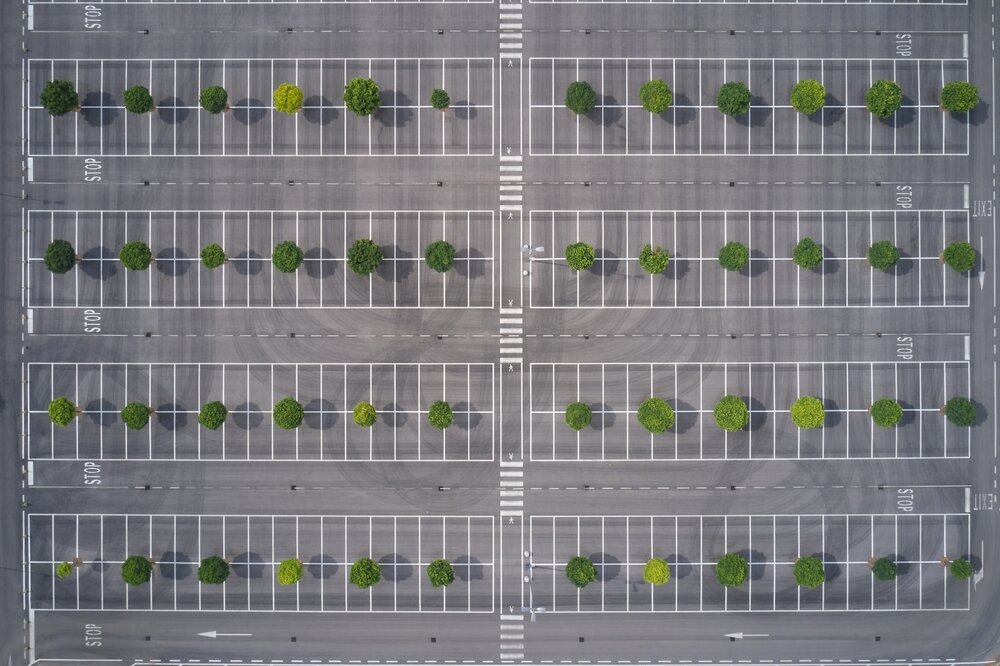 landscaping islands within the parking lot. New Parking Lot With Drone View.